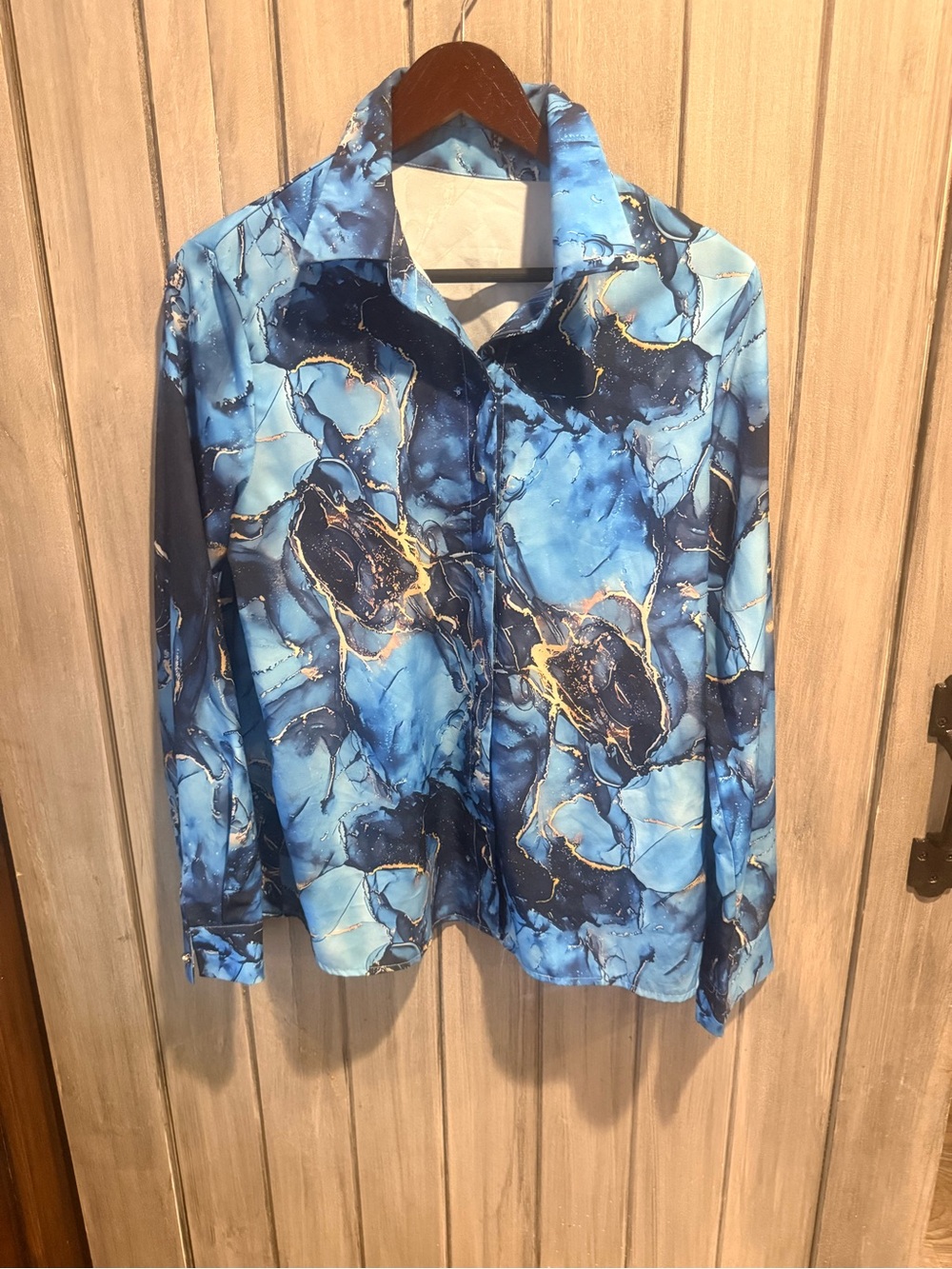 Blouse with blue marble print and gold accents. Long sleeve, ladies large